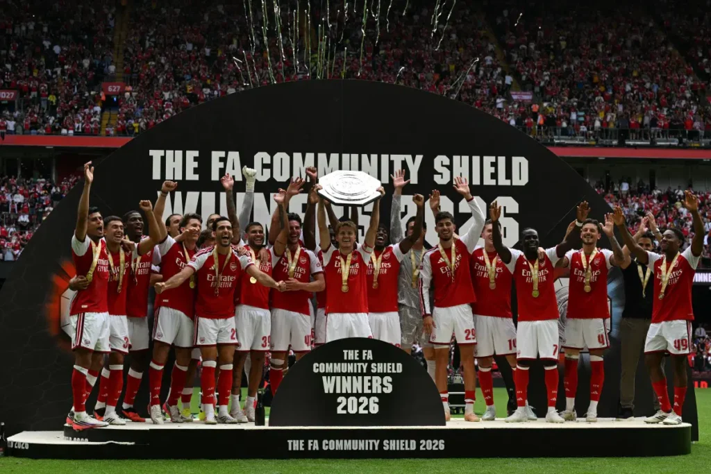 Arsenal’s Norwegian midfielder #08 Martin Odegaard lifts the trophy as Arsenal’s players celebrate their victory after the English FA Community Shield football match between Arsenal and Manchester City at The Principality Stadium, in Cardiff, south Wales on August 16, 2026. Arsenal won the game 3-0. (Photo by Glyn KIRK / AFP)