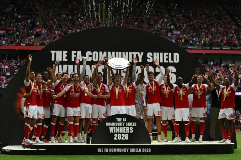 Arsenal’s Norwegian midfielder #08 Martin Odegaard lifts the trophy as Arsenal’s players celebrate their victory after the English FA Community Shield football match between Arsenal and Manchester City at The Principality Stadium, in Cardiff, south Wales on August 16, 2026. Arsenal won the game 3-0. (Photo by Glyn KIRK / AFP)